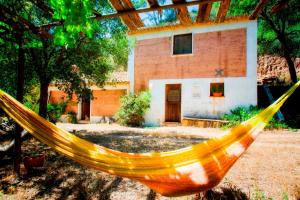 a hammock in front of a house at Casas da Cerca in Troviscais