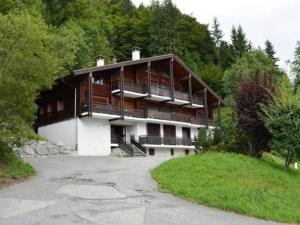 a house on a hill with a parking lot at Appartement Le Grand-Bornand, 1 pièce, 4 personnes - FR-1-241-141 in Le Grand-Bornand