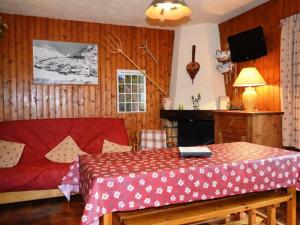 a bedroom with a red bed and a fireplace at Appartement Le Grand-Bornand, 2 pièces, 6 personnes - FR-1-241-152 in Le Grand-Bornand