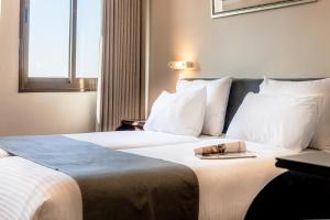 Ένα ή περισσότερα κρεβάτια σε δωμάτιο στο Jerusalem Gate Hotel