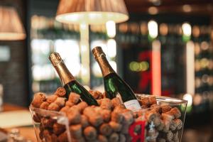 two bottles of champagne and a container of nuts at Holiday Club Saimaan Rauha Apartments in Imatra +93 photos