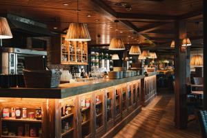 a bar in a restaurant with lights at Holiday Club Saimaan Rauha Apartments in Imatra