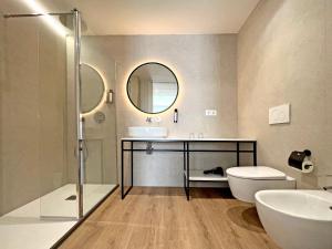 a bathroom with a sink and a toilet and a mirror at Soho Boutique Turia in Valencia