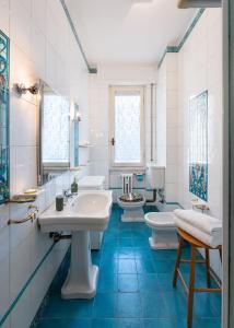 a bathroom with three sinks and two toilets at Beccaria - Flo Apartments in Florence