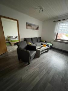 a living room with a couch and a window at Ferienwohnung am grünen Haus in Garz-Rügen