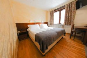 Postel nebo postele na pokoji v ubytování HOTEL SPORTING
