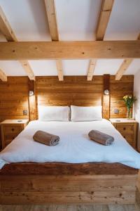 a bedroom with a bed with two pillows on it at Chalet Dranse Winter Ski Summer Vtt Hot Tubsauna in Saint-Jean-dʼAulps