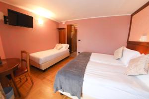 Postel nebo postele na pokoji v ubytování HOTEL SPORTING
