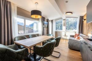 a kitchen and dining room with a table and chairs at Zugspitz Residence Ehrwald in Ehrwald
