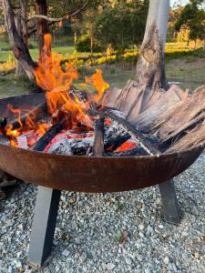 a fire pit with flames burning in it at Adina Tiny House Bruny Island in South Bruny