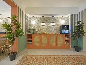 a kitchen with wooden cabinets and plants in a room at Soho Boutique Turia in Valencia