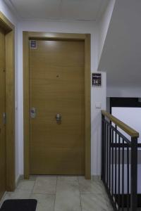 a wooden door in a hallway with a staircase at Estudio Alicante Barrio 2 in Alicante