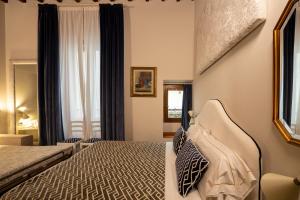 a hotel room with a bed and a window at Hotel Maxim Axial in Florence