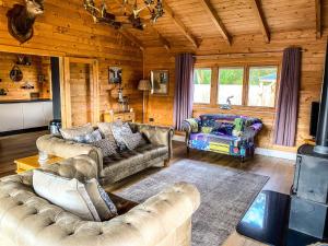 a living room with couches and a fireplace in a cabin at Beautiful 3-Bed Luxury Private Lodge in York in York