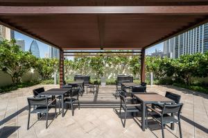 a group of tables and chairs on a patio at Luxury StayCation - Fancy Apartment Connected To Burj Khalifa in Dubai