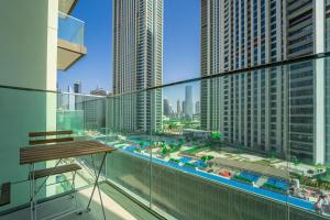a balcony with a view of a city with tall buildings at Luxury StayCation - Fancy Apartment Connected To Burj Khalifa in Dubai