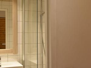 a glass shower in a bathroom with a sink at Appartement Méribel, 1 pièce, 4 personnes - FR-1-180-206 in Méribel