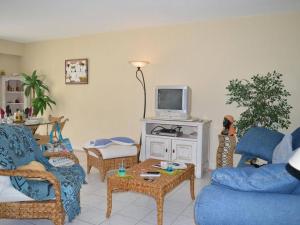 un soggiorno con mobili blu e TV di Appartement Saint-Raphaël, 3 pièces, 4 personnes - FR-1-226A-46 a Saint-Raphaël