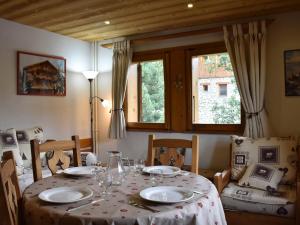 a dining room table with plates and glasses on it at Appartement Méribel, 2 pièces, 4 personnes - FR-1-180-207 in Méribel