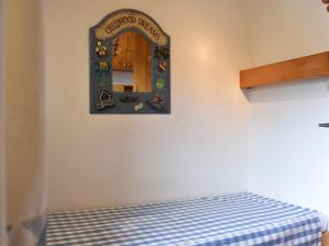 a room with a bed with a sign on the wall at Appartement Méribel, 2 pièces, 4 personnes - FR-1-180-207 in Méribel