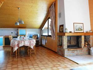 a dining room with a table and a fireplace at Appartement Le Grand-Bornand, 3 pièces, 7 personnes - FR-1-241-50 in Le Grand-Bornand