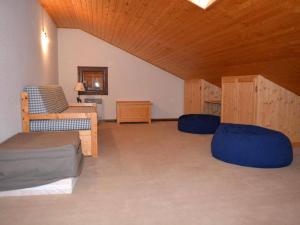 a living room with a bed and a couch at Appartement Le Grand-Bornand, 3 pièces, 7 personnes - FR-1-241-50 in Le Grand-Bornand