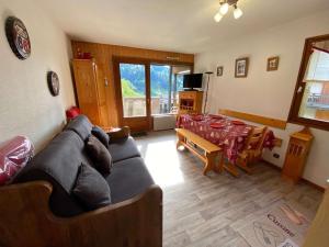 a living room with a couch and a table at Appartement Le Grand-Bornand, 2 pièces, 6 personnes - FR-1-241-52 in Le Grand-Bornand