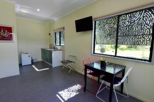 a room with a table and chairs and a window at Daintree Peaks ECO Stays in Daintree