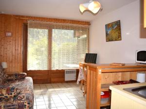 a kitchen with a desk and a window with a laptop at Appartement Le Grand-Bornand, 1 pièce, 4 personnes - FR-1-241-51 in Le Grand-Bornand