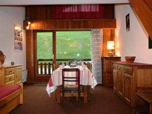 a dining room with a table and a large window at Appartement Le Grand-Bornand, 1 pièce, 6 personnes - FR-1-241-5 in Le Grand-Bornand