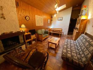 a living room with a couch and a fireplace at Appartement Le Grand-Bornand, 2 pièces, 6 personnes - FR-1-241-120 in Le Grand-Bornand