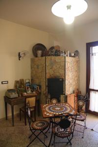 a living room with a table and a fireplace at "Green" B&B Il Bracco in Partinico