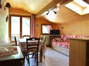 a living room with a bed and a table in a room at Appartement Le Grand-Bornand, 2 pièces, 6 personnes - FR-1-241-94 in Le Grand-Bornand