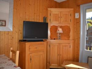 a television on top of a wooden cabinet in a room at Appartement Le Grand-Bornand, 1 pièce, 4 personnes - FR-1-241-129 in Le Grand-Bornand