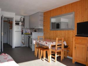 a kitchen with a table and chairs and a television at Appartement Le Grand-Bornand, 1 pièce, 4 personnes - FR-1-241-129 in Le Grand-Bornand