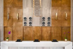 una habitación con una mesa blanca y algunos platos en la pared en Wyndham Doha West Bay en Doha