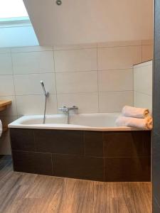 a bath tub with a towel on top of it at Appartement Aigner in Mauterndorf