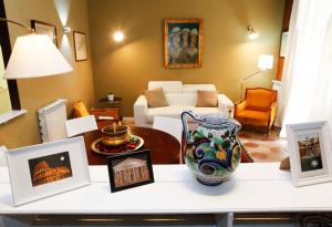 a living room with a table with a vase on it at APPARTAMENTO CON TERRAZZINO AL PANTHEON in Rome