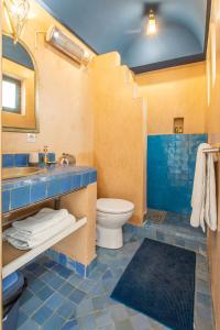 a blue bathroom with a sink and a toilet at Riad Myla - 2mn de Jemaa El Fna in Marrakech