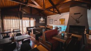 a restaurant with tables and chairs in a room at Tico Pousada - Campos do Jordão in Campos do Jordão