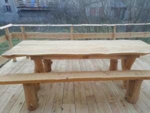 a wooden bench sitting on top of a wooden deck at Maison de montagne dans charmant village du Capcir in Fontrabiouse