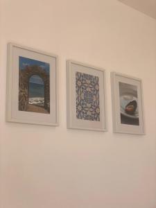 three framed pictures on a white wall at Valhalla Panorama - the old Residencial Pina in Funchal