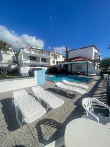 a group of white benches sitting next to a pool at Valhalla Panorama - the old Residencial Pina in Funchal