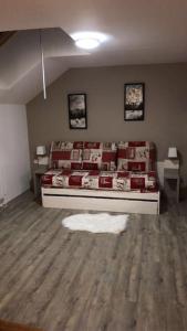a bedroom with a bed and a white rug on the floor at Au bout du bois Piscine sauna hammam accessible en saison et le logement accessible toute l annee in Les Déserts