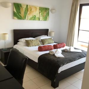 a bedroom with a bed with two pillows on it at Tortuga Beach Villa in Santa Maria