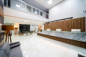 a lobby with a couch and a reception counter at Stop Way Hotel Fortaleza in Fortaleza