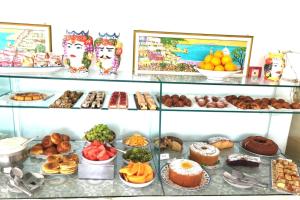 a display case filled with lots of different types of food at Hotel Ossidiana Stromboli Center in Stromboli