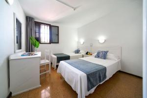 Posteľ alebo postele v izbe v ubytovaní Apartamentos Río Piedras