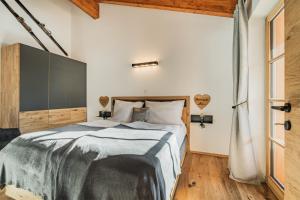 a bedroom with a large bed and a window at Dachstein West Apartment T5 in Russbach am Pass Gschütt