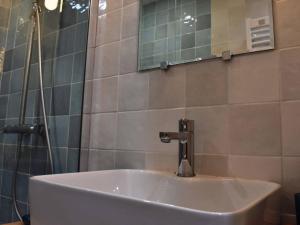 a white sink in a bathroom with a mirror at Chalet Méribel, 5 pièces, 12 personnes - FR-1-180-191 in Méribel